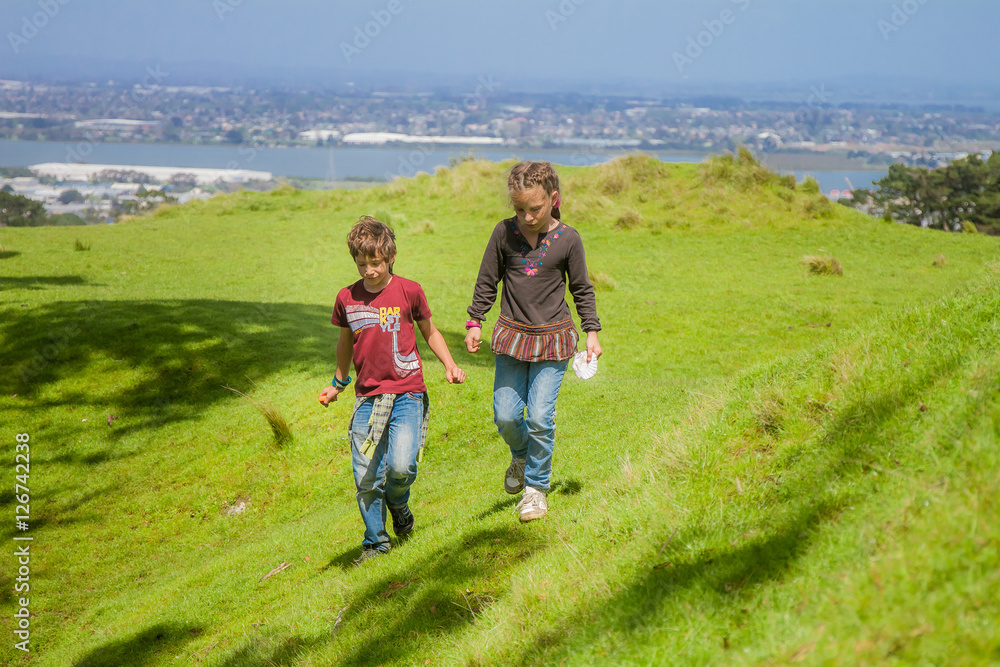 two young kids - boy and girl - hiking on natural background