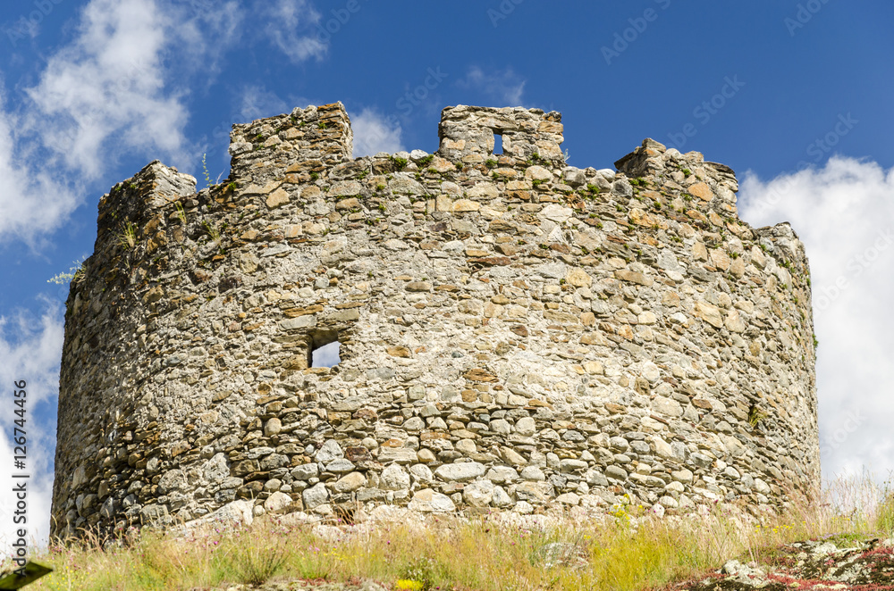 middleages castle on top of the mountain, bottom view of the ruin of the castle. 