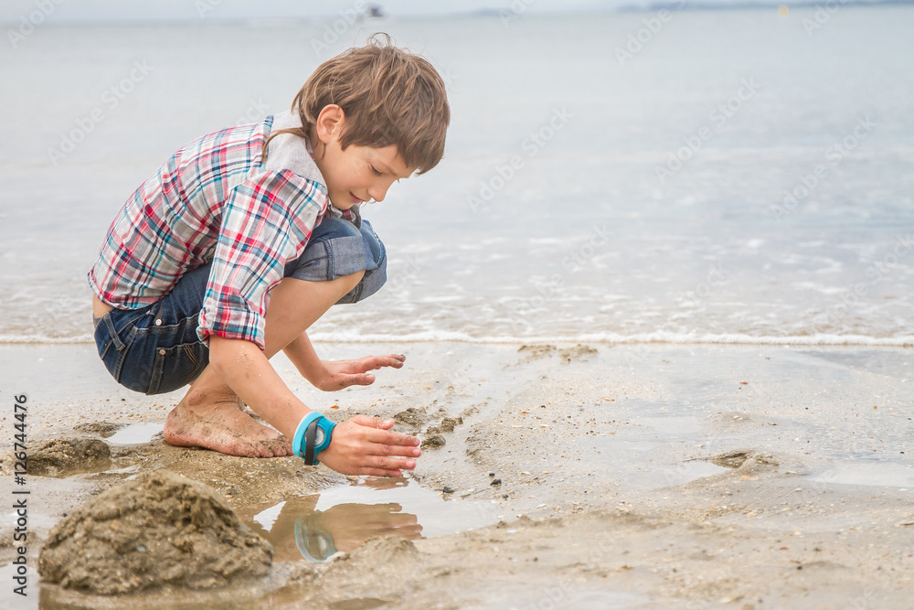 Happy child boy having fun on natural sea background Happy child boy having fun on natural sea background