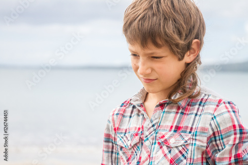 outdoor portrait of young boy on natural sea background