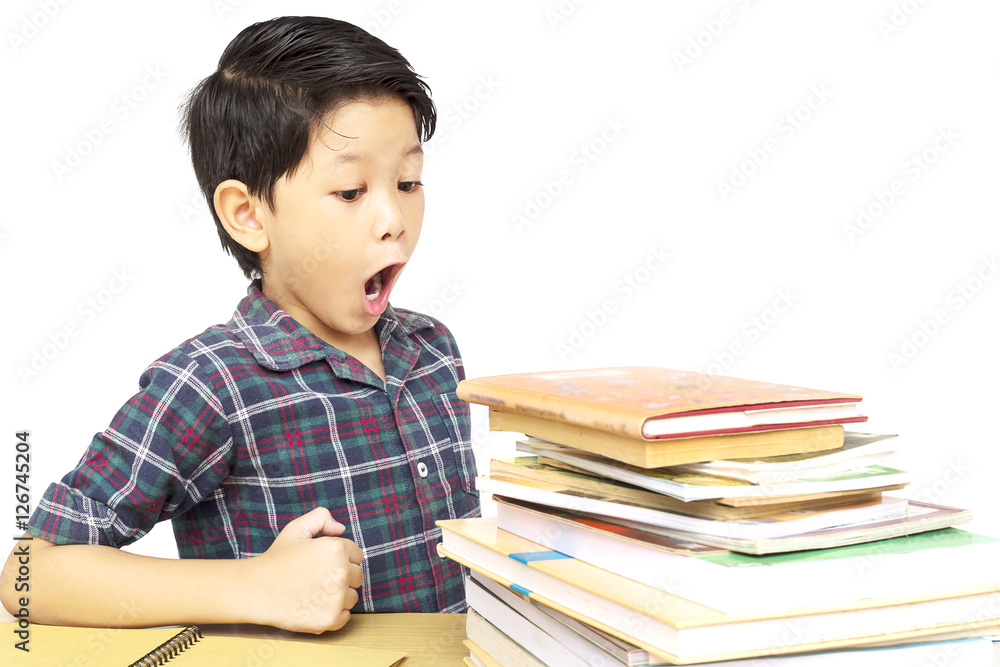 Asian boy is shouting while looking at a pile of book isolated over white background Asian boy is shouting while looking at a pile of book isolated over white background