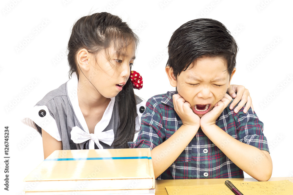 Sister try to teach her naughty younger brother to read a book isolated over white background Sister try to teach her naughty younger brother to read a book isolated over white background