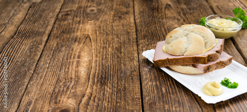 Portion of German Leberkaese on wooden background (selective foc