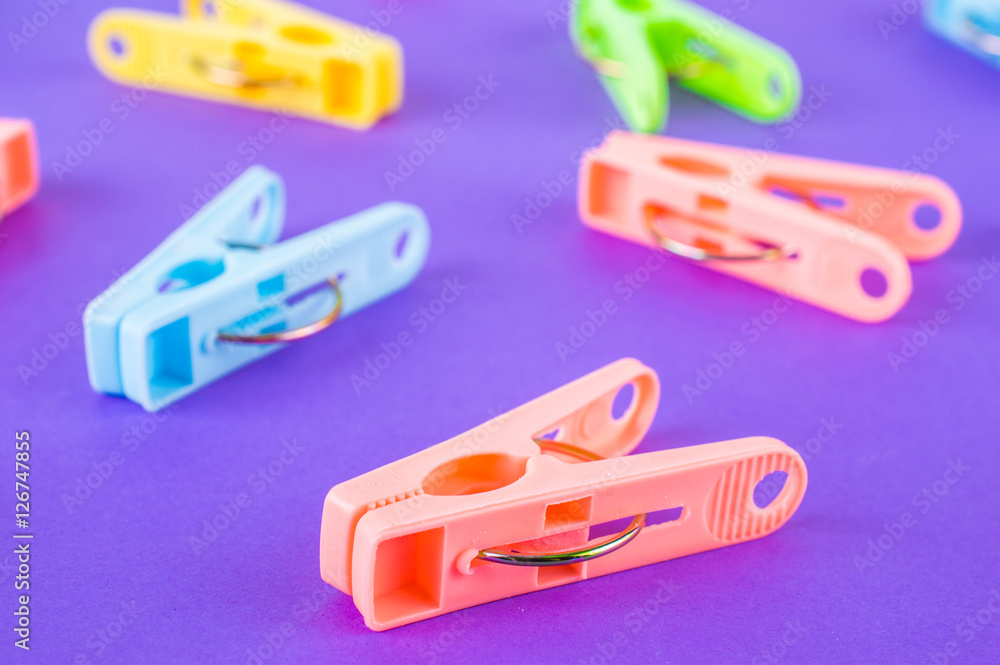 colorful clothespins isolated on purple background colorful clothespins isolated on purple background