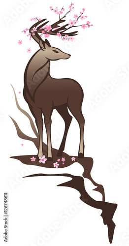 spring season wildlife - deer standing on a cliff among pink flowers