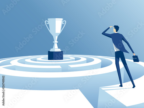 businessman has climbed to the top of the maze and trying to find the way to the cup, worker looks how to get through the maze and get a prize. business concept the way to victory