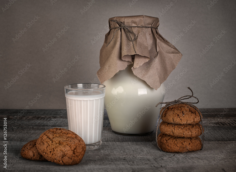glass of milk and homemade cookies on wooden table