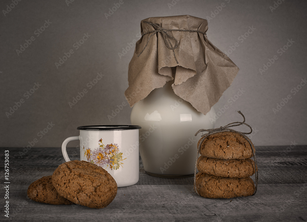 cup and jar of milk and homemade cookies on wooden table