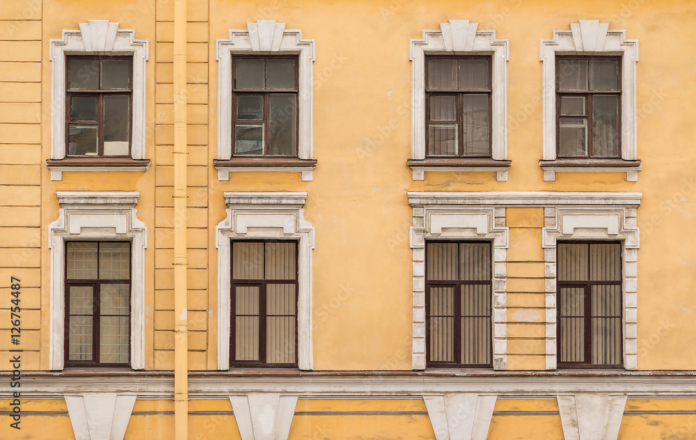 Several windows in a row on facade of the urban office building front view, St. Petersburg, Russia.