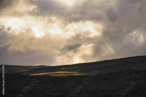 Golden light shining on swedisch mountain landscape. Sarek