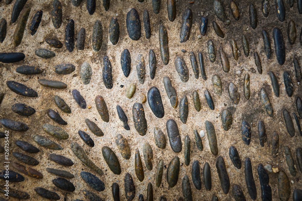 Round stones in the ground, Cobblestones in concrete background. Round stones in the ground, Cobblestones in concrete background.