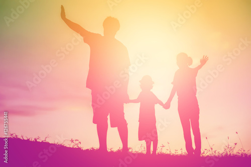 silhouette of a happy family and happy time sunset © chaunpis