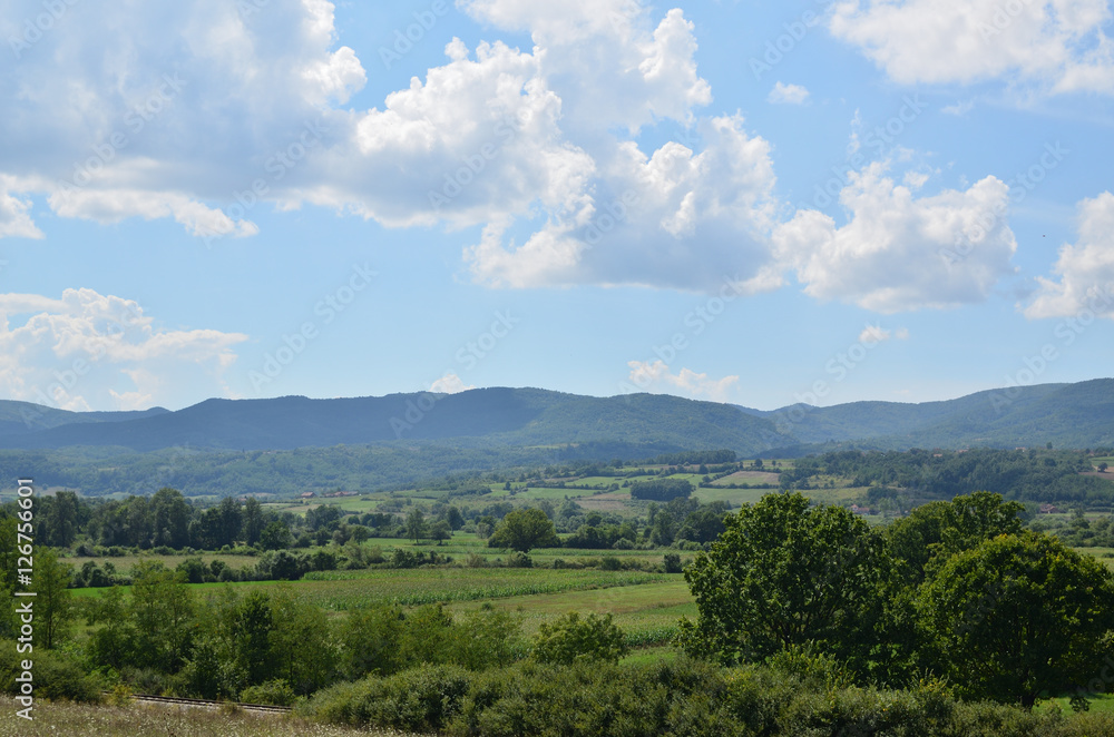 Landscape of central Serbia with fields and mountain in background