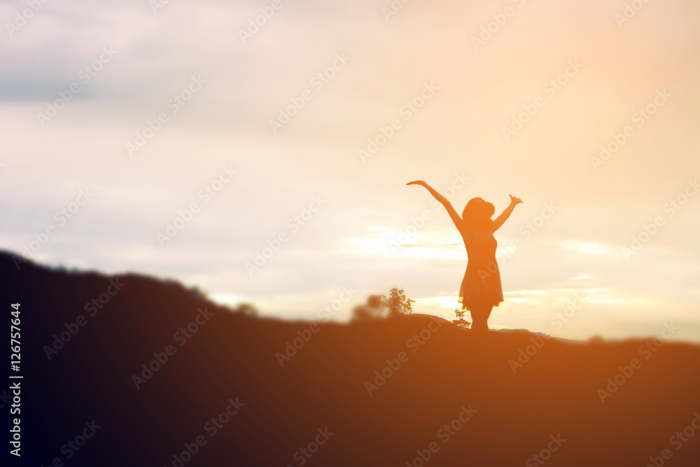 Silhouette of woman praying over beautiful sky background Silhouette of woman praying over beautiful sky background