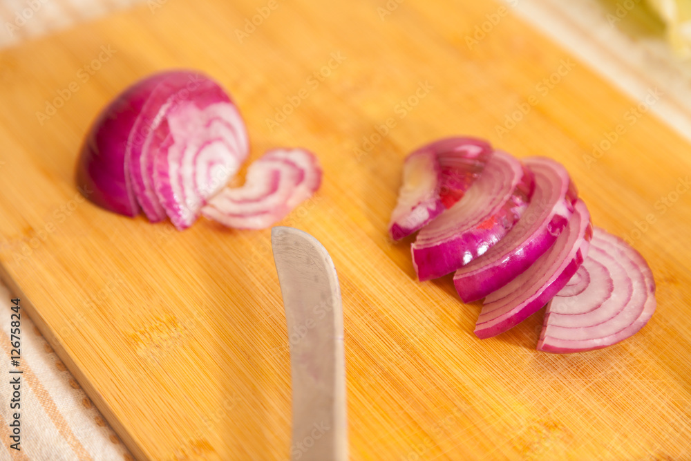 cropped onion with other vegetables on a cutting board cropped onion with other vegetables on a cutting board