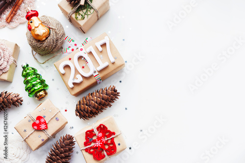Christmas and New Year background with handmade presents wrapped in craft paper and decorations, holiday symbols. Place for text.