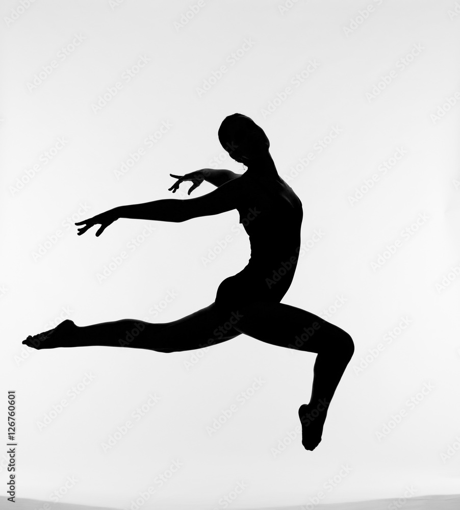 Silhouette of jumping female ballet dancer 