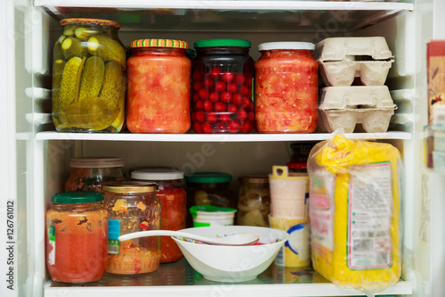 Pickled vegetables in jars in refrigerator