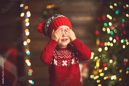 little girl  in anticipation of a Christmas miracle and a gift photo