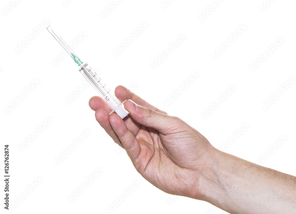 Hand holding syringe with needle isolated on white Hand holding syringe with needle isolated on white