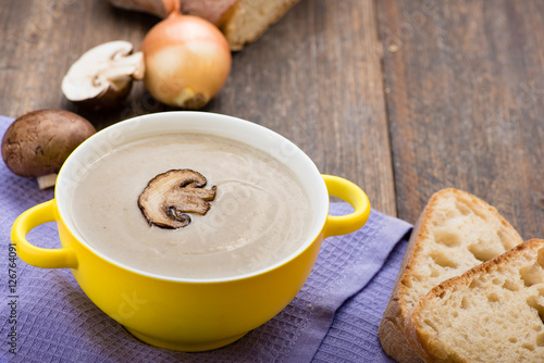 Mushroom cream soup on the wooden table.