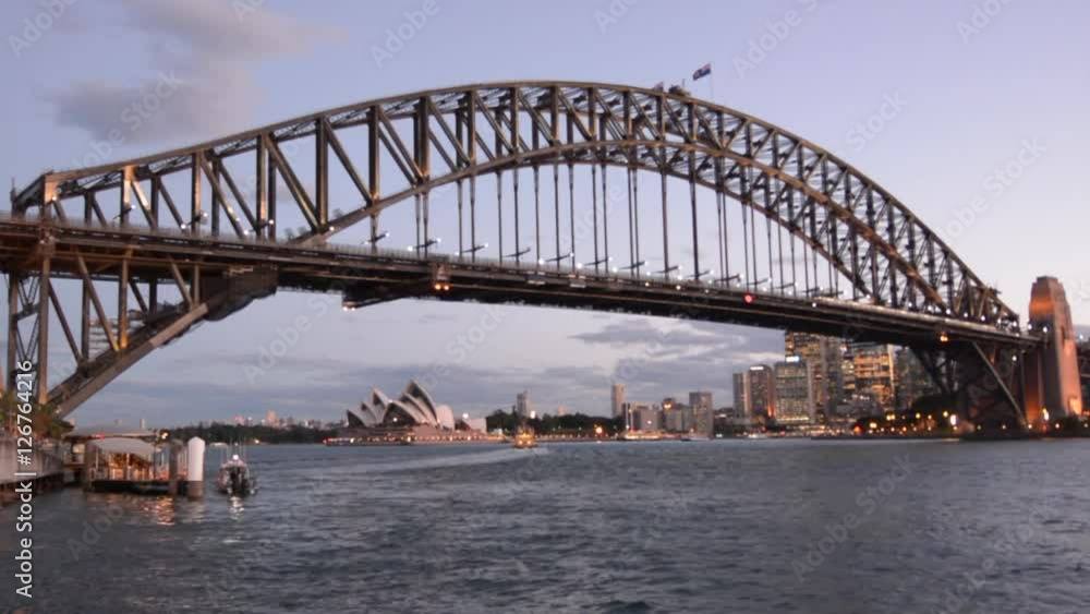 Sydney Trains pass over the Sydney Harbour Bridge west side and Sydney Skyline during sunset in New South Walles, Australia . Sydney Trains pass over the Sydney Harbour Bridge west side and Sydney Skyline during sunset in New South Walles, Australia .