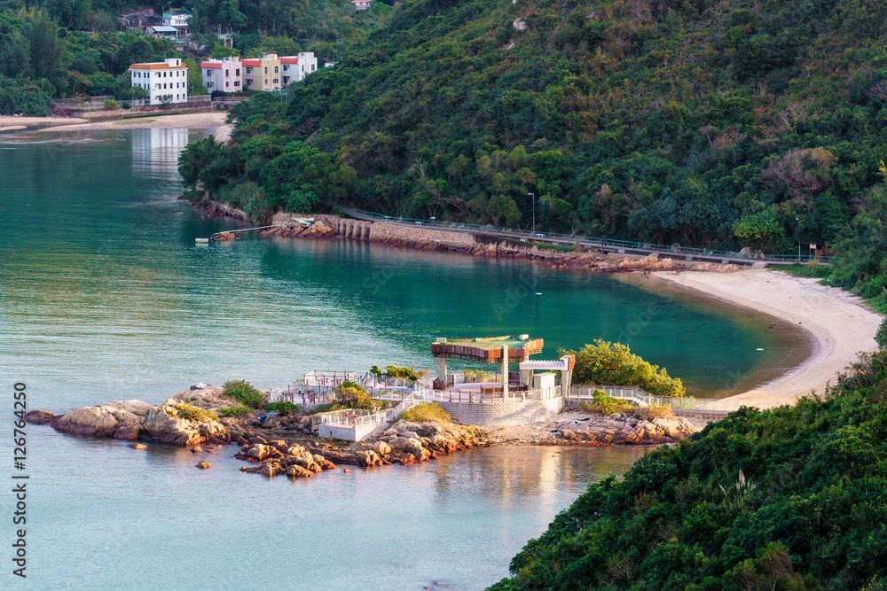 Fototapeta premium An openair cafe in Sok Kwu Wan fisherfolks village viewed from the observation deck of the Family Walk trail on Lamma Island, Hong Kong