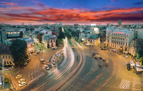 Beautiful long exposure shot of Piata Romana in Bucharest, Romania. Panorama of traffic, street and a starry night.