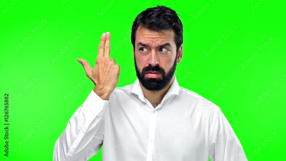 Handsome man making suicide gesture on green screen chroma key Handsome man making suicide gesture on green screen chroma key
