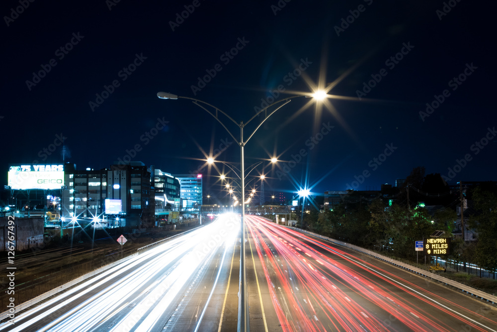 Long Exposure of Highway Car Lights Vanishing Into the Distance at Night