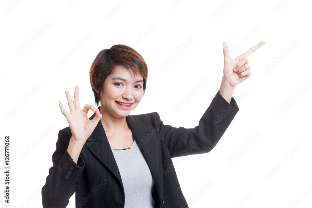 Young Asian business woman point and show OK. Young Asian business woman point and show OK.
