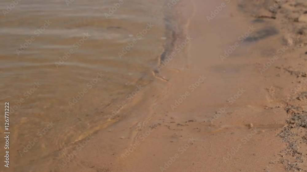 A girl with a pink pedicure steps into river water A girl with a pink pedicure steps into river water