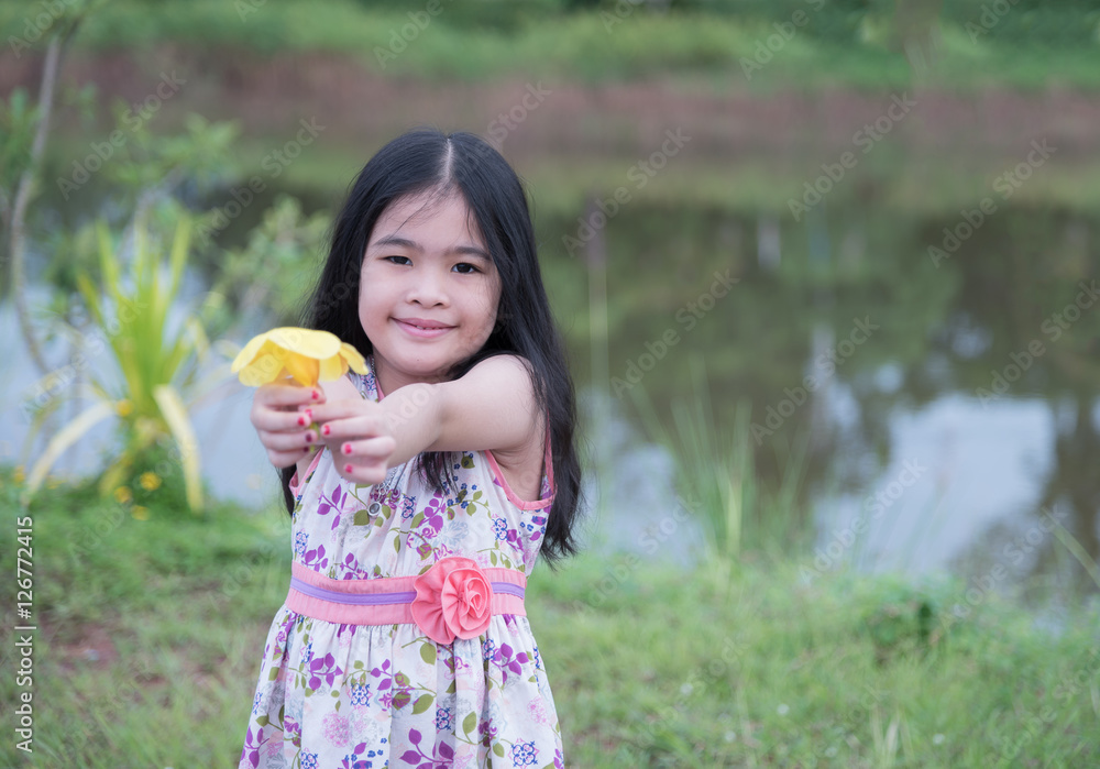 Little girl with bunch of yellow tulips outdoors Little girl with bunch of yellow tulips outdoors