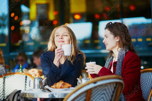 Two young girls in Parisian outdoor cafe