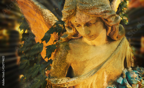 Majestic view of statue of golden angel illuminated by sunlight photo