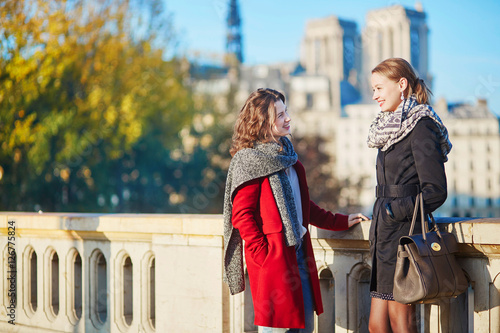Two young girls walking together in Paris