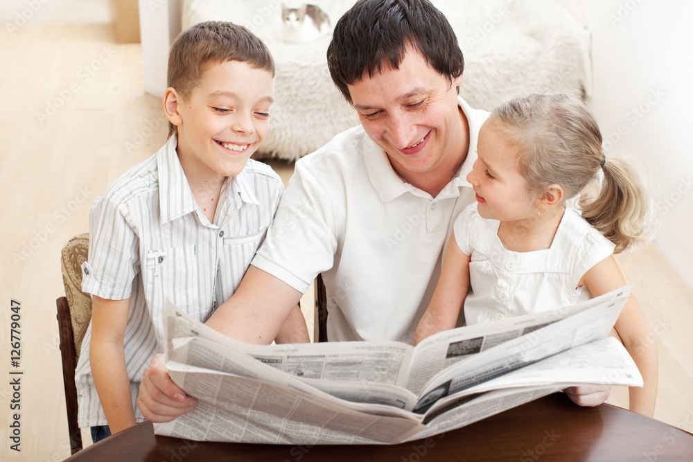 Family reading a newspaper