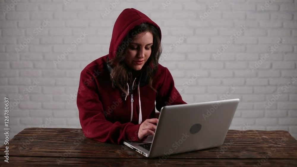 On laptop is working woman-hacker