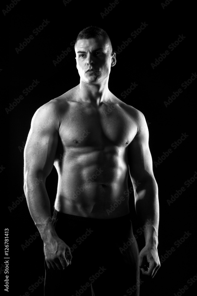 Strong young man showing his muscles Strong young man showing his muscles