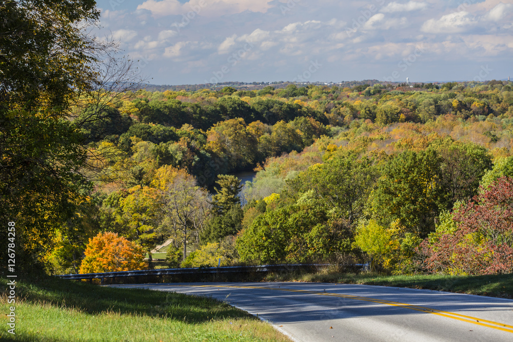 Obraz premium Hilltop road and distant fall landscape