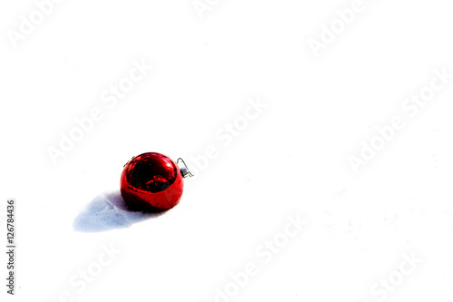 Bright red Christmas ball in snow