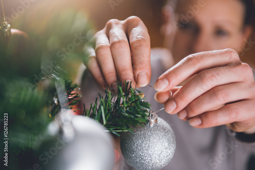 Woman decorating christmas tree