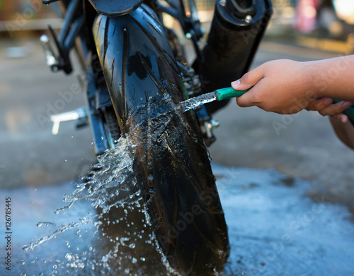 close up washing a motorcycle wheel.