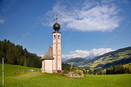 church in the foothills of the Dolomites. Funes Valley, Dolomites, Italy. St John church under autumn sun