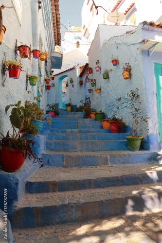 Street full of colorful pots in Chefchaouen, Morocco © juanorihuela