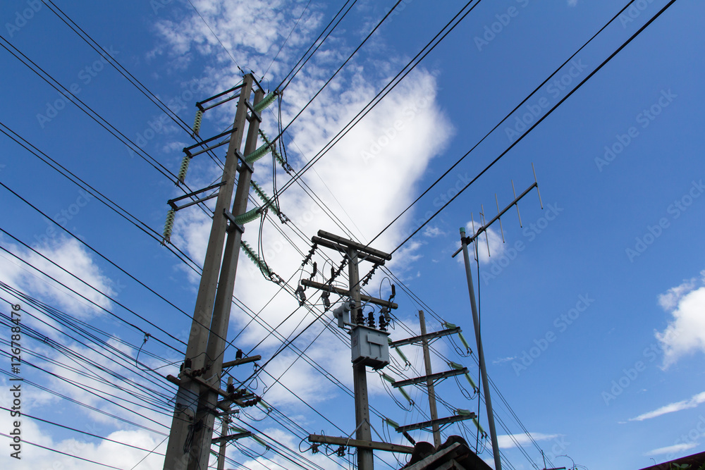 Abstract Power line against the blue sky. Electrical poles of high voltage in white cloud and blue sky. Abstract Power line against the blue sky. Electrical poles of high voltage in white cloud and blue sky.