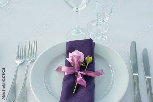Festive table setting in the restaurant with flowers. Wedding decor.