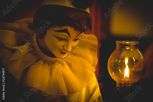 Bozo doll hold quill pen and Light of lamp photo