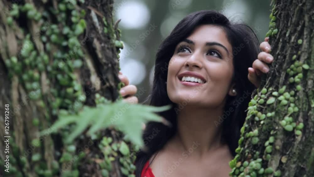MS Portrait of young woman between branches of tree / Singapore MS Portrait of young woman between branches of tree / Singapore