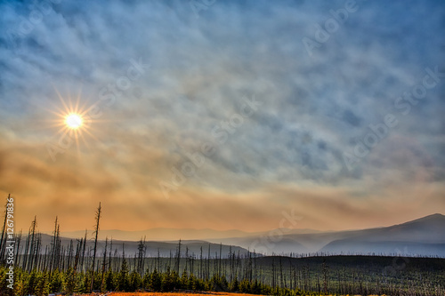Smoke from neaby forest fires. fill the sky over Yellowstone National Park in the late afternoon. photo